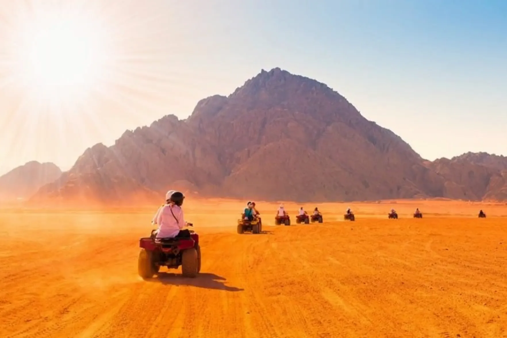 Quad trails · dust and dunes at sunset